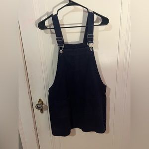 Overalls dress. Dark blue, corduroy, medium. Two pockets in front.